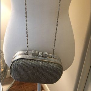 Evening silver purse with a long chain strap.